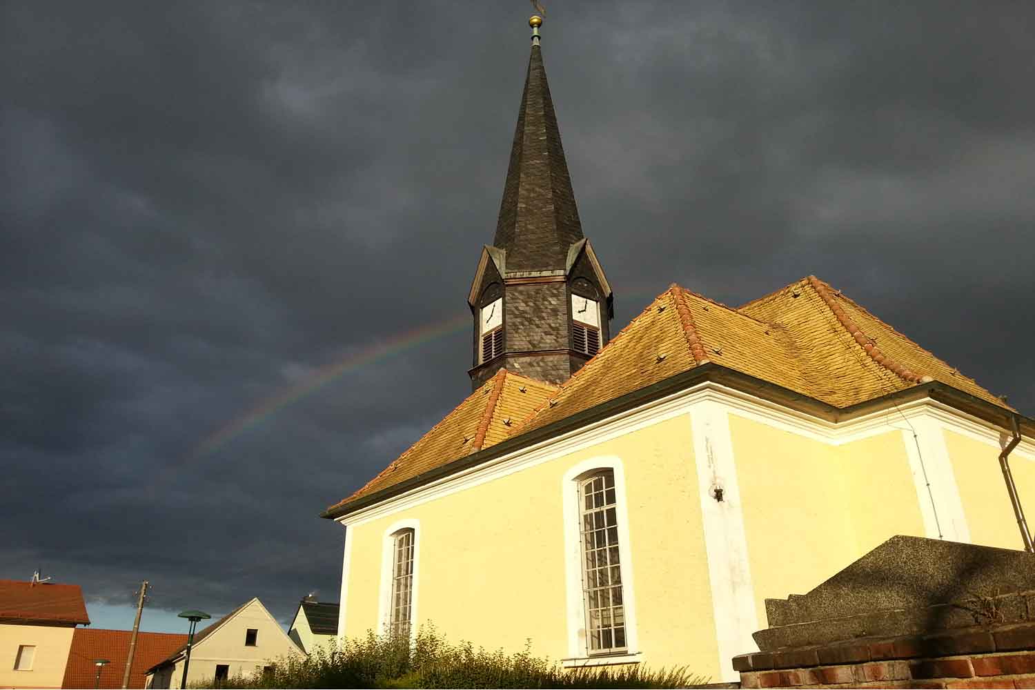 Kirche Miltitz bei Leipzig mit Uhrturm und Regenbogen Kirchturm mit Regenbogen und Uhr